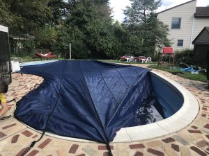 pool cover being installed