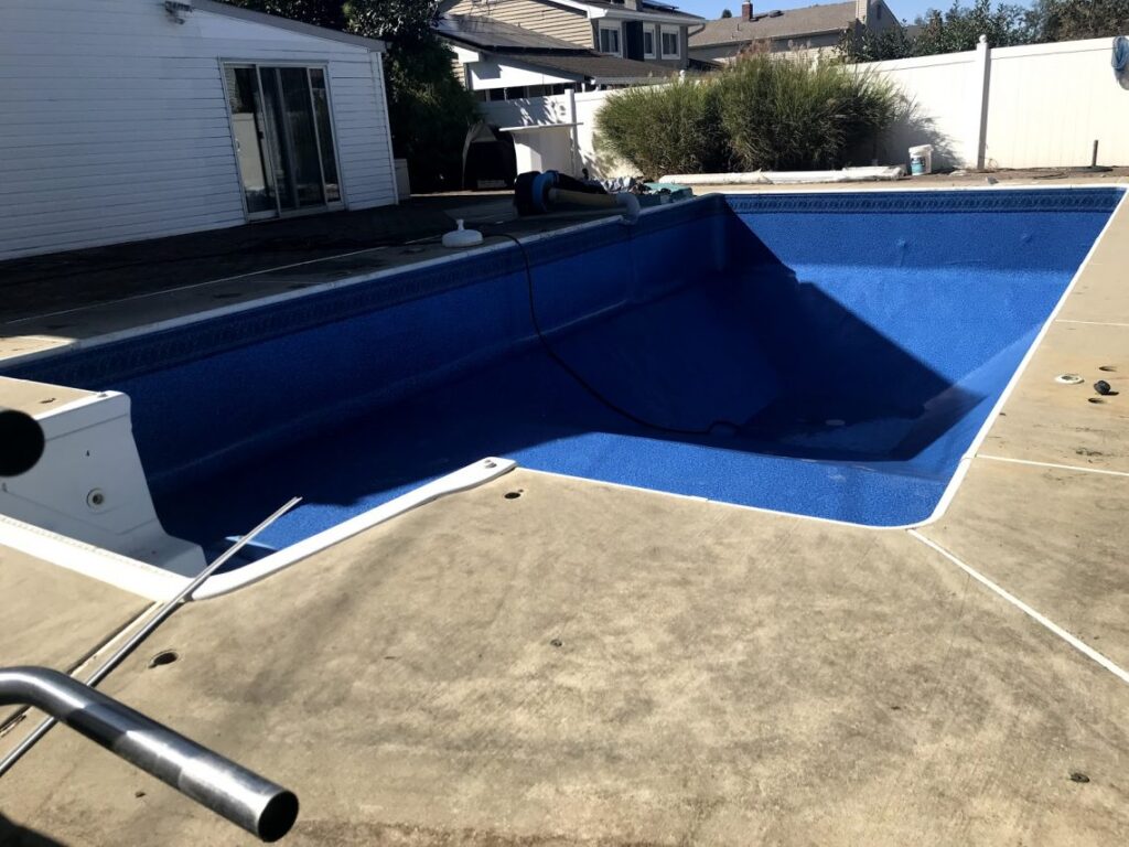 An empty pool in the process of being installed.