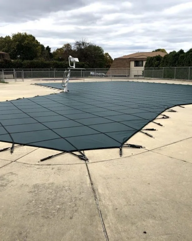 solid pool cover covering backyard pool