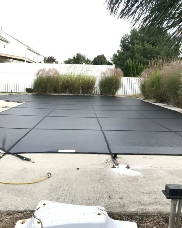 solid pool cover covering backyard pool