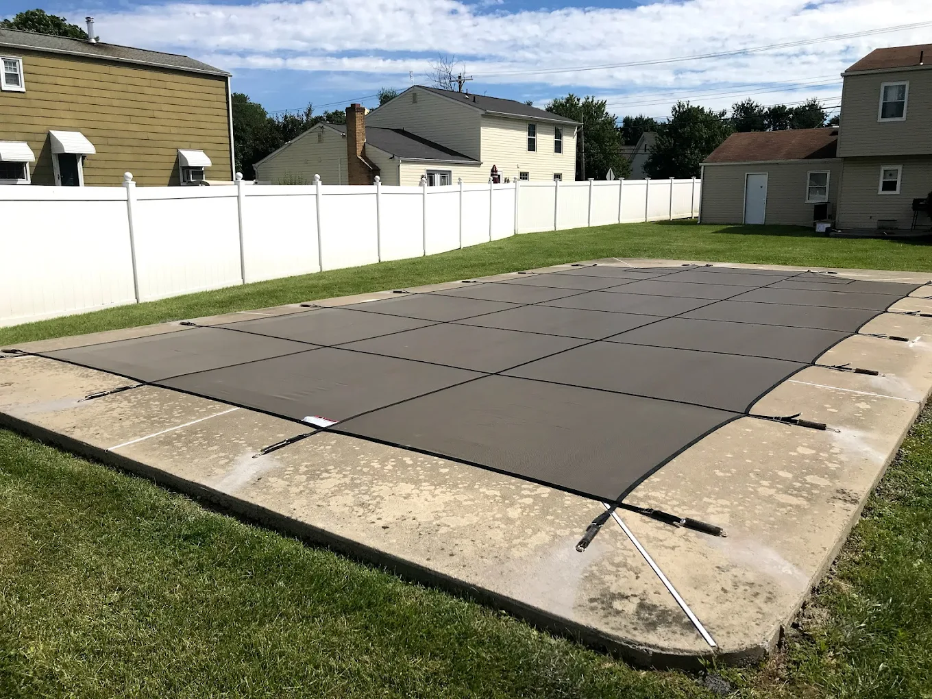 solid pool cover covering backyard pool