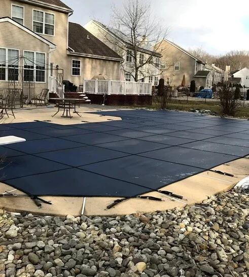 solid pool cover covering backyard pool