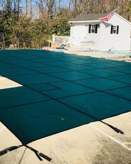 solid pool cover covering backyard pool