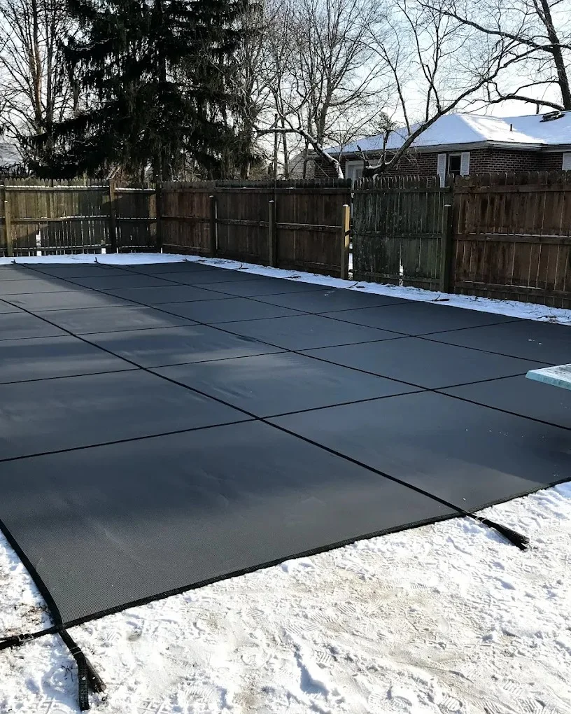 solid pool cover covering backyard pool