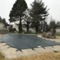 backyard swimming pool with safety cover installed