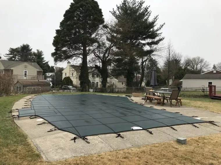 backyard swimming pool with safety cover installed